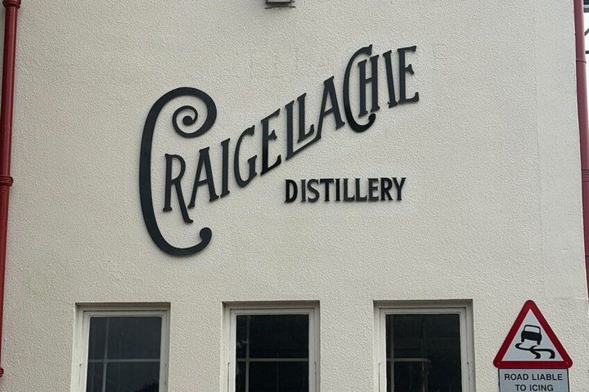 The exterior of Craigellachie Distillery with a road sign indicating icy conditions. 4