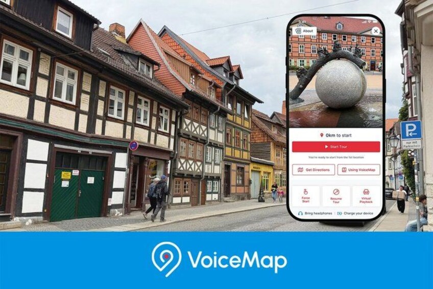A smartphone displaying a map application with a medieval European street scene in the background. 1