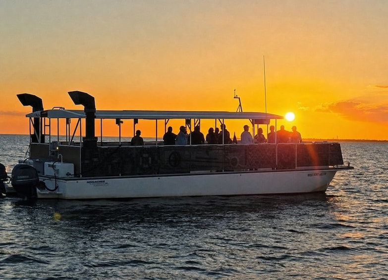 A boat with people on board during sunset. 2
