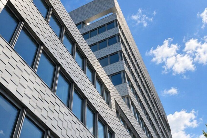 A modern building with a patterned facade and large windows. 3