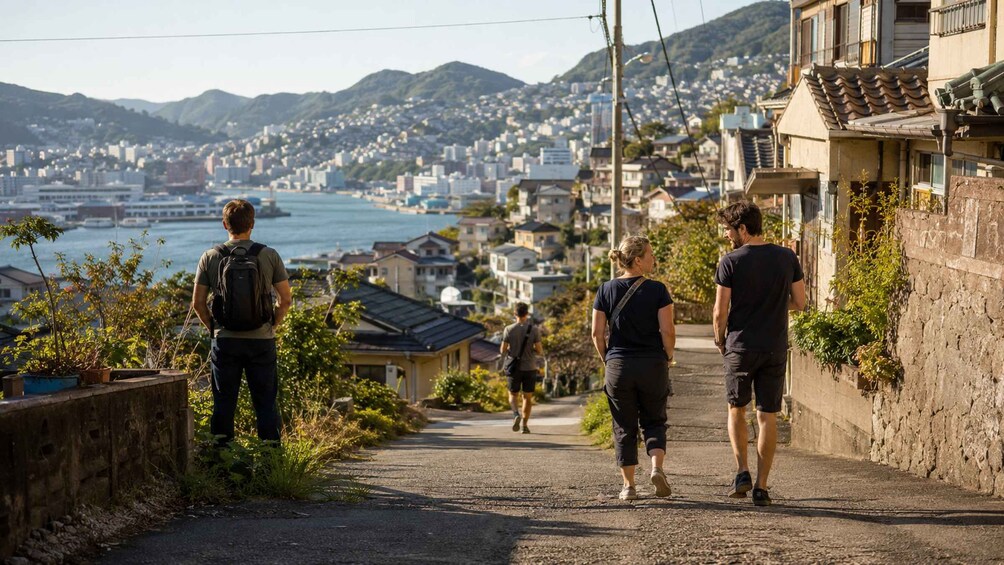 A coastal street with houses, a view of the sea, and mountains in the background. 4