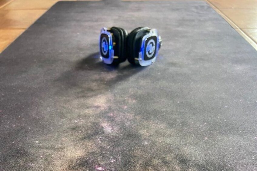 A pair of black and blue headphones on a textured surface. 2
