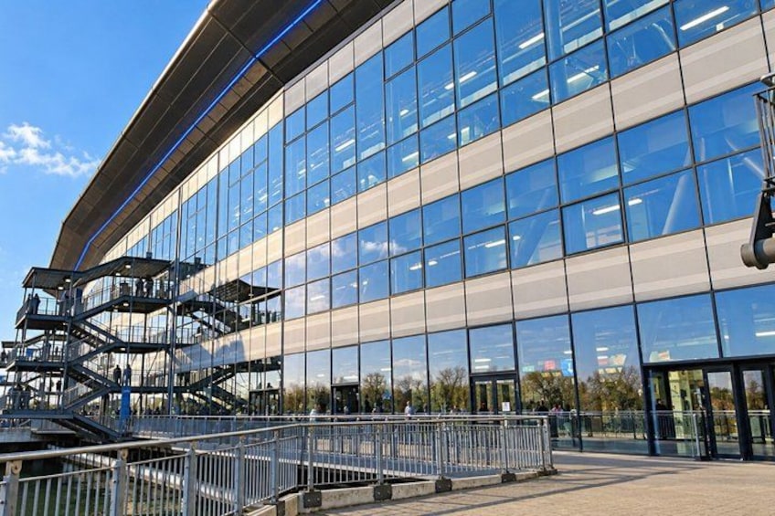 A modern building with large glass windows and a curved facade. 5