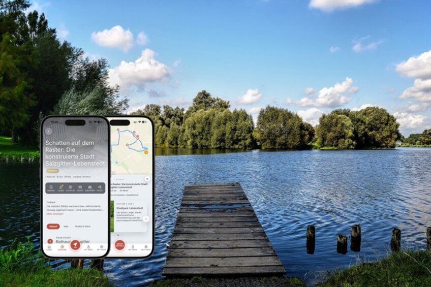 A smartphone displaying a map with a wooden dock extending into a lake surrounded by trees. 1