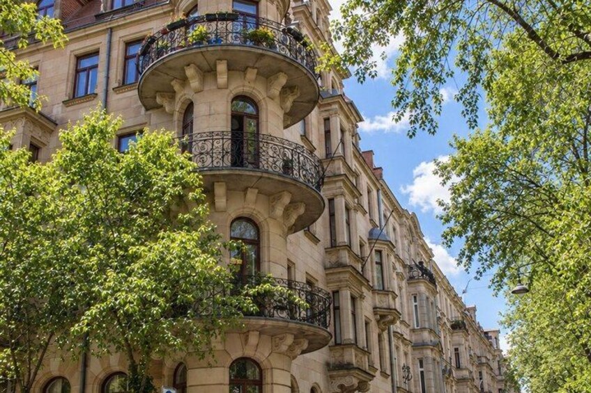 A historic building with ornate balconies and arched windows. 3