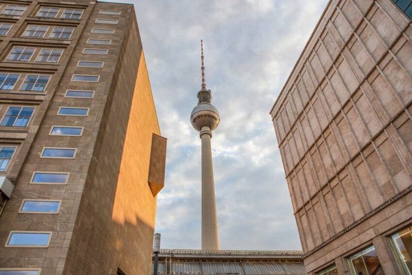 A tall tower with a spherical observation deck, surrounded by modern buildings. 5
