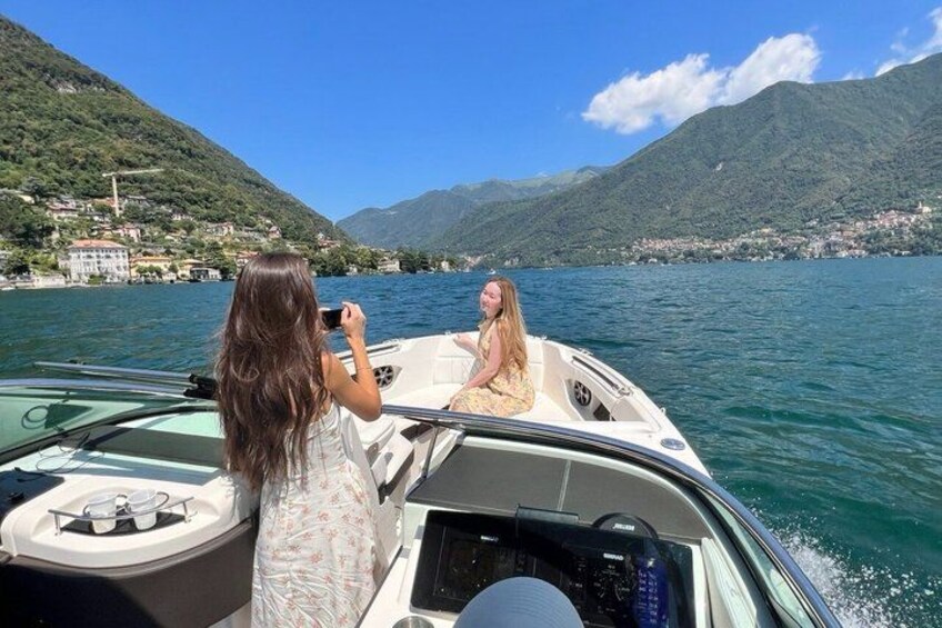 A boat on a lake with mountains in the background. 5