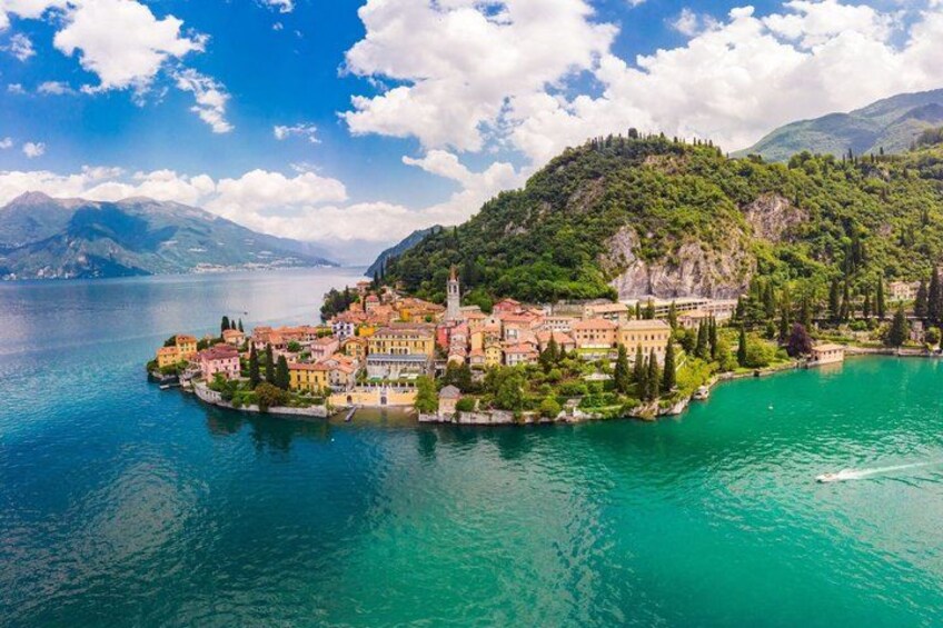 A coastal town with buildings, a church, and a lake. 1
