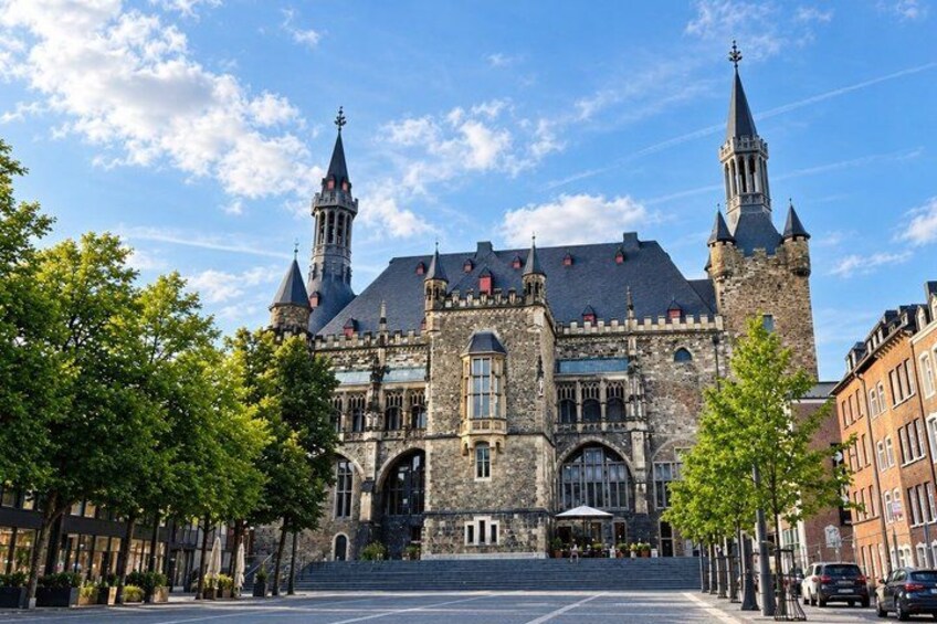 A historic building with two towers and a large arched entrance. 5