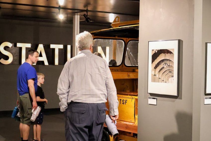 A group of people viewing artworks in an indoor gallery. 4