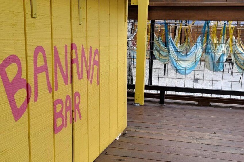 A yellow wooden structure with 'BANANA BAR' written on it. 4