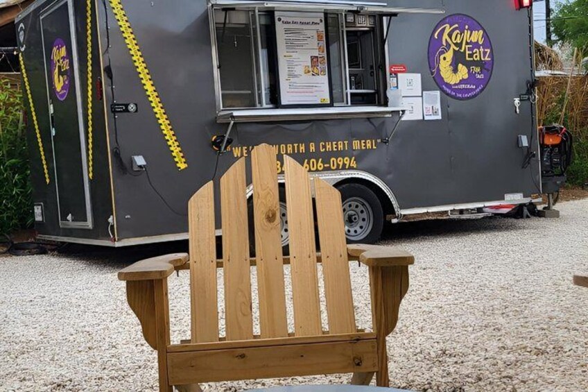 A food truck with a wooden chair in front. 3