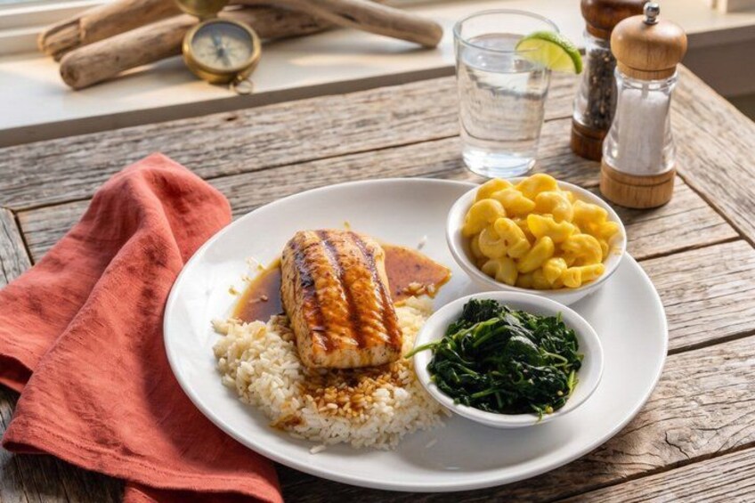A plate of food with rice, a grilled fish, macaroni, and greens. 2