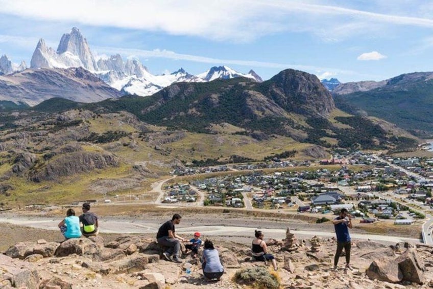 A mountainous landscape with a town in the valley, rocky terrain, and a clear sky. 4