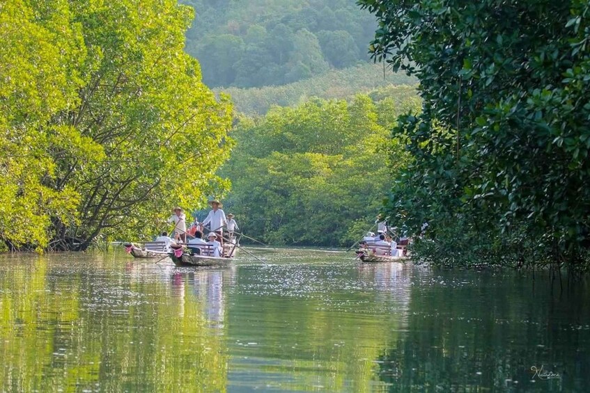 A calm river with boats and people. 4