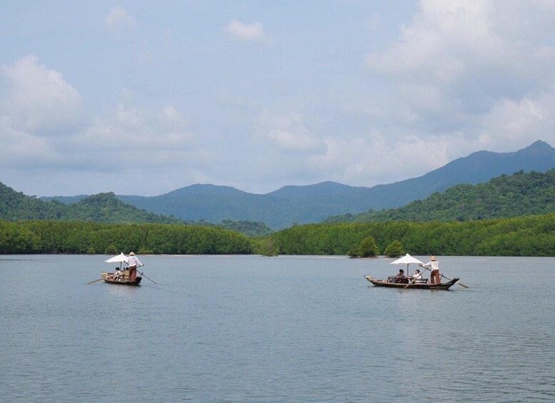 Two boats on a calm lake with mountains in the background. 5
