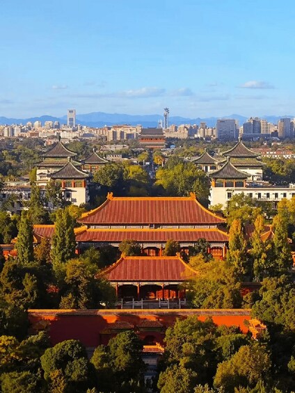 Un ensemble architectural chinois traditionnel, composé de plusieurs bâtiments de style pagode, entouré d’une végétation luxuriante et avec une vue sur la ville en arrière-plan. 5