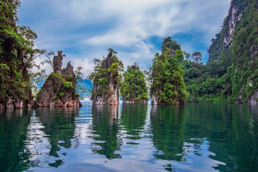 A calm river surrounded by lush greenery and rocky formations. 1