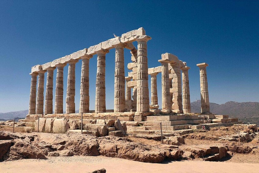 Ancient Greek ruins with columns and stone structures. 3