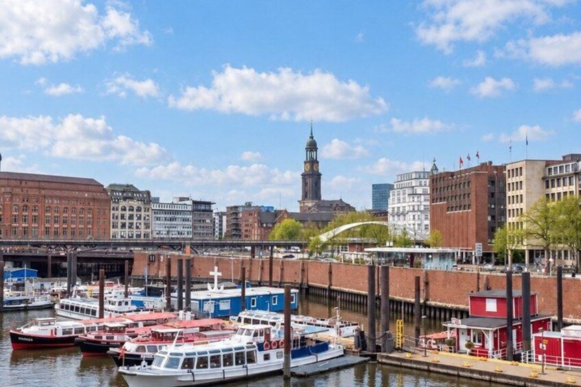 A harbor with boats, a bridge, and historic buildings. 2
