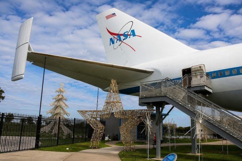 A NASA aircraft with a star-shaped structure and stairs leading to the entrance. 3