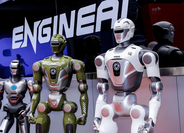 Three humanoid robots with different color schemes and designs, standing in front of a backdrop with the word 'ENGINEAL'. 1