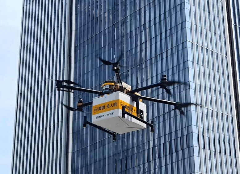 A drone hovering in front of a tall building with reflective glass windows. 5