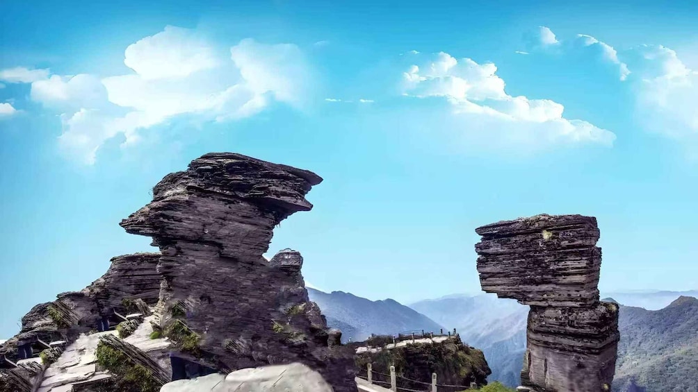 Rock formations with a clear sky and distant mountains. 5