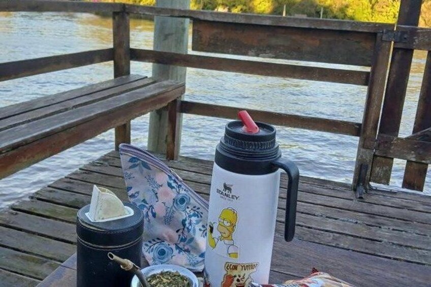 A picnic setup on a wooden dock with a water body in the background. 3