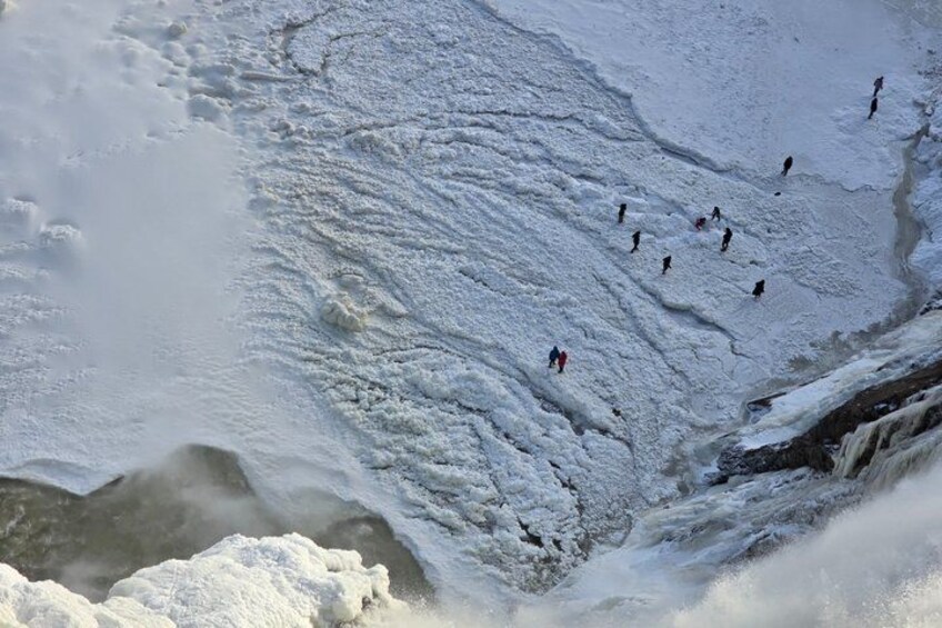 A snowy landscape with a river flowing through it. 3
