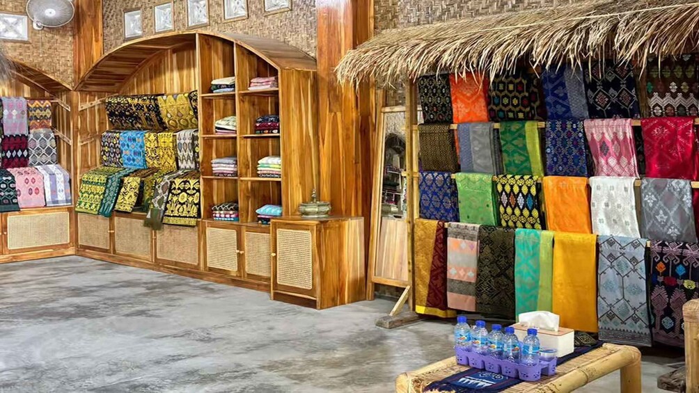 A traditional market with wooden shelves displaying colorful textiles. 5