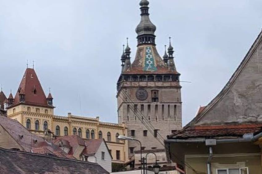 A historic building with a clock tower and a spire. 3