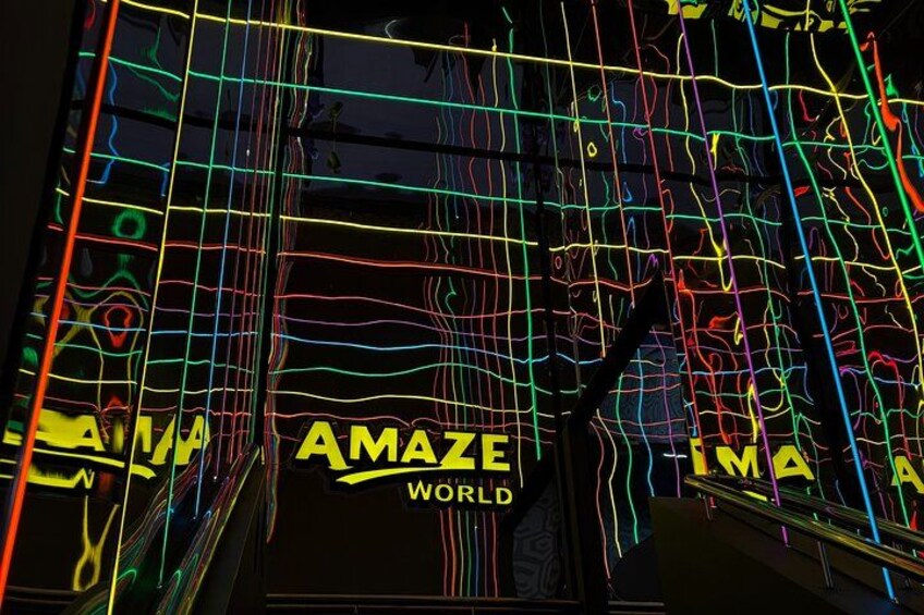 A neon-lit structure with the words 'AMAZE WORLD' prominently displayed. 3