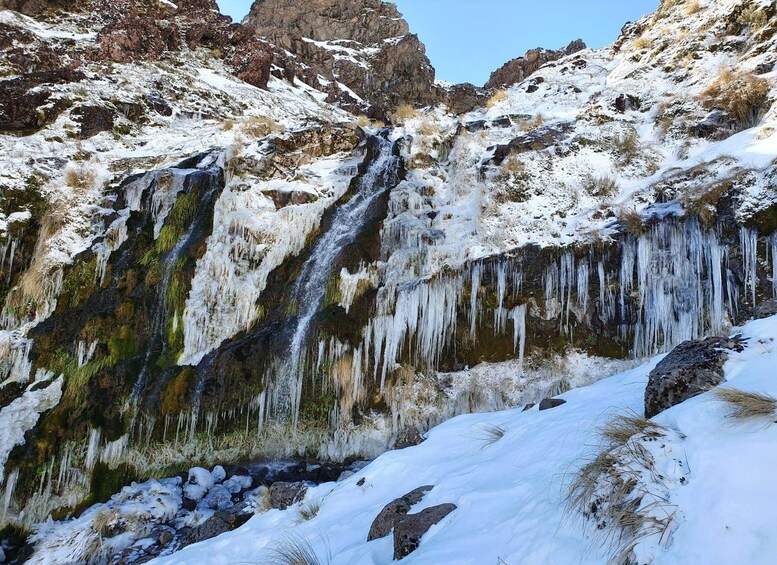 A snow-covered waterfall with icicles. 2