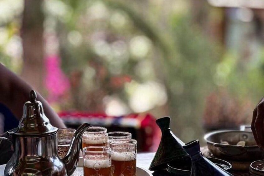 A traditional Moroccan tea set with glasses and a teapot. 3