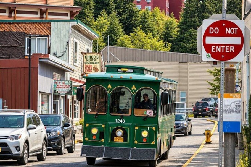 A green trolley with the number 1246, a 'DO NOT ENTER' sign, and a 'Chico's Mexican Restaurant' sign. 4