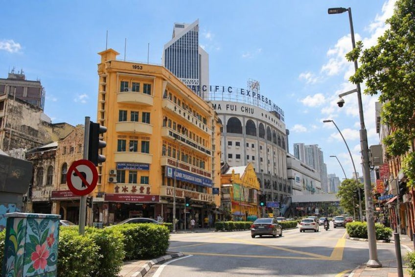 A city street with buildings, including a hotel and a restaurant. 5