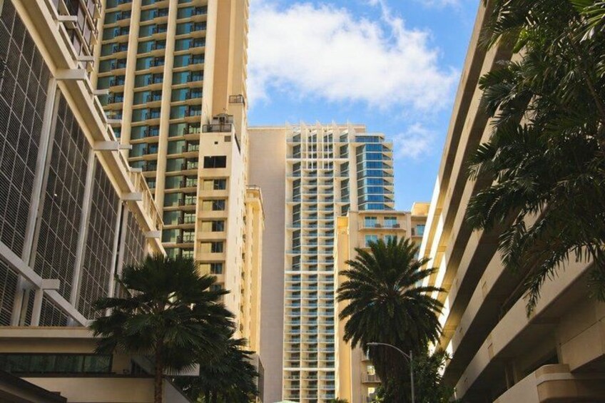 Tall residential buildings, palm trees, and a clear sky. 4