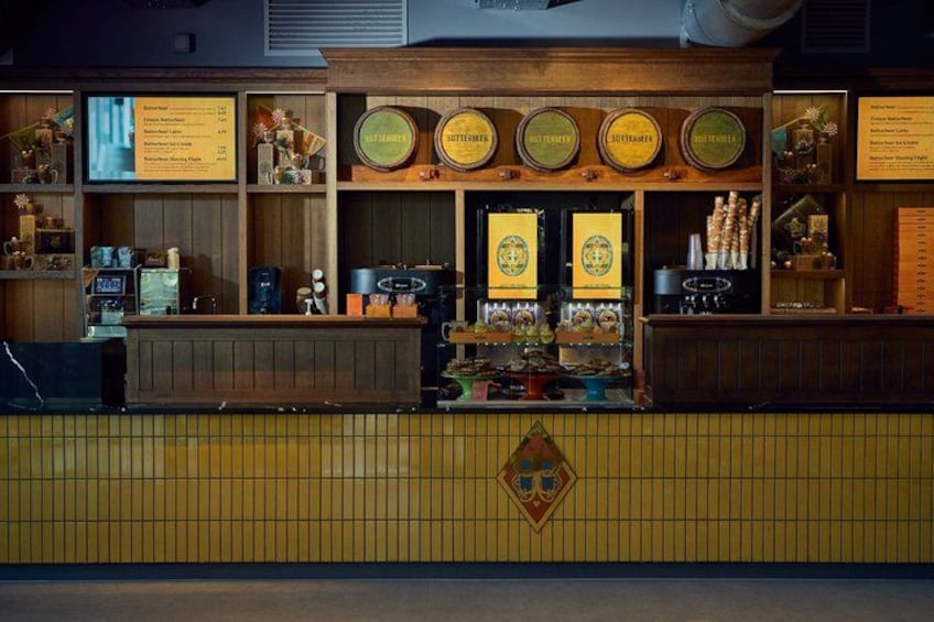 A bar with wooden shelves, beer taps, and a menu board. 1