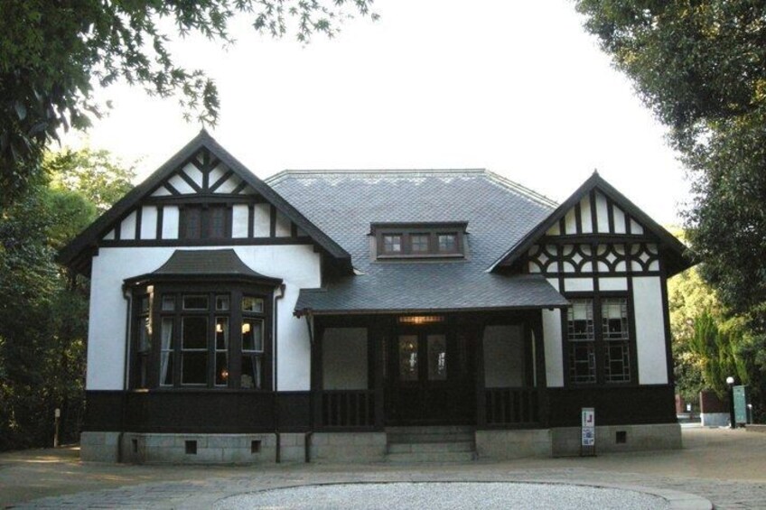A Tudor-style building with a steeply pitched roof, white walls, and black timber framing. 4