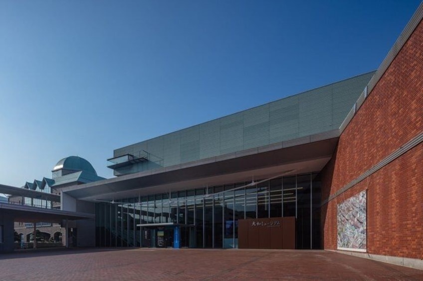 A modern building with a glass facade and a brick exterior. 5