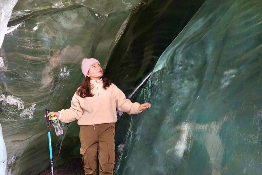 A person inside a cave with ice formations. 3