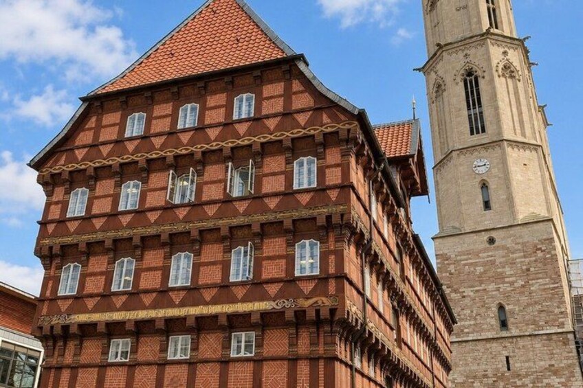 A red brick building with a tower and a clock. 5