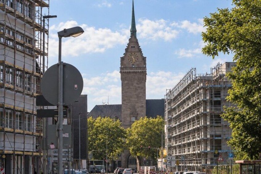 A clock tower, a street lamp, and construction scaffolding. 4