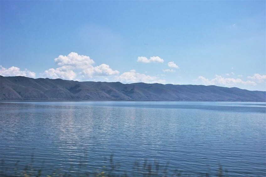 A calm lake with mountains in the background. 2