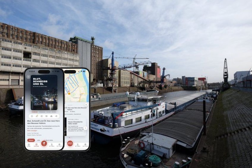 A river with a boat, a bridge, and industrial buildings. 1