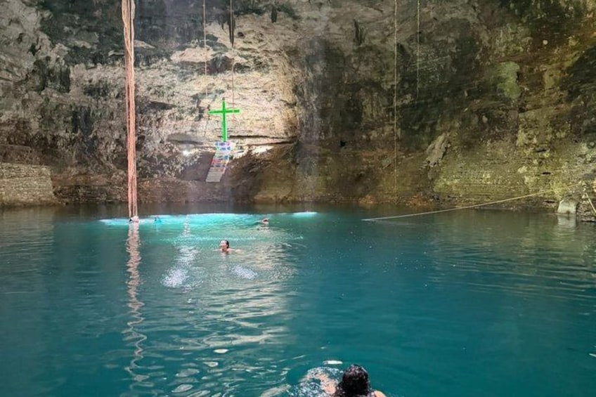 A natural pool with clear water, surrounded by rocky cliffs. 5