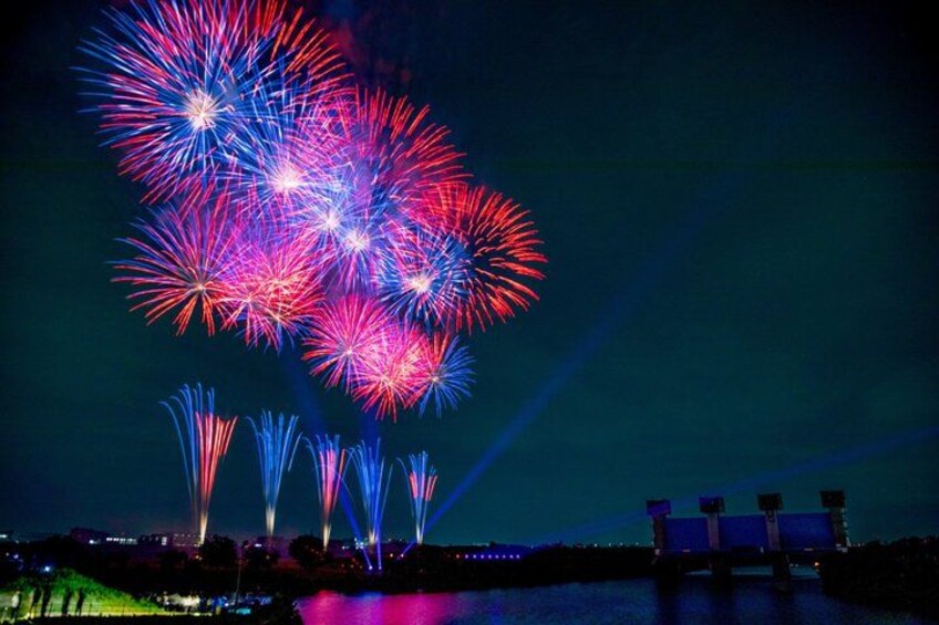 Fireworks over a body of water with a dark sky. 2