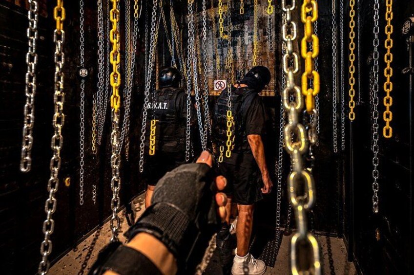 A person climbing a chain obstacle course. 2