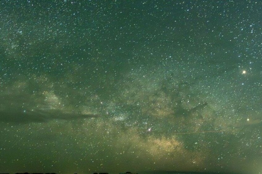 A starry night sky with visible stars and a faintly visible galaxy. 5